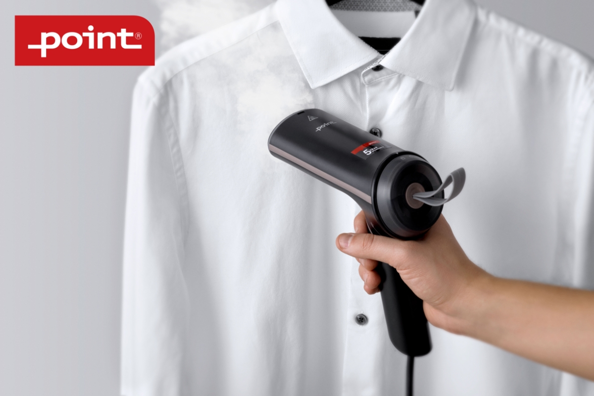 A black Point travel steamer in a person's hand steaming a white collar shirt that is hanging on a hanger with a white background and a red and white Point-logo on the left upper corner
