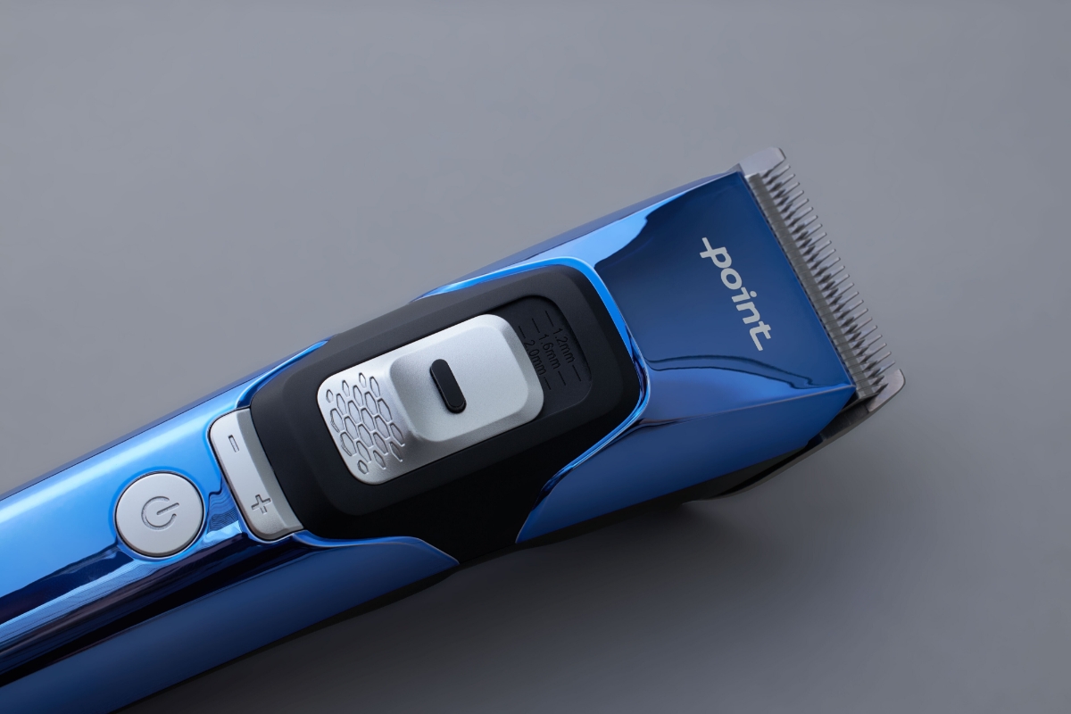 Close up of the shaving head of POINT TRIM TECH BEARD TRIMMER on dark grey background