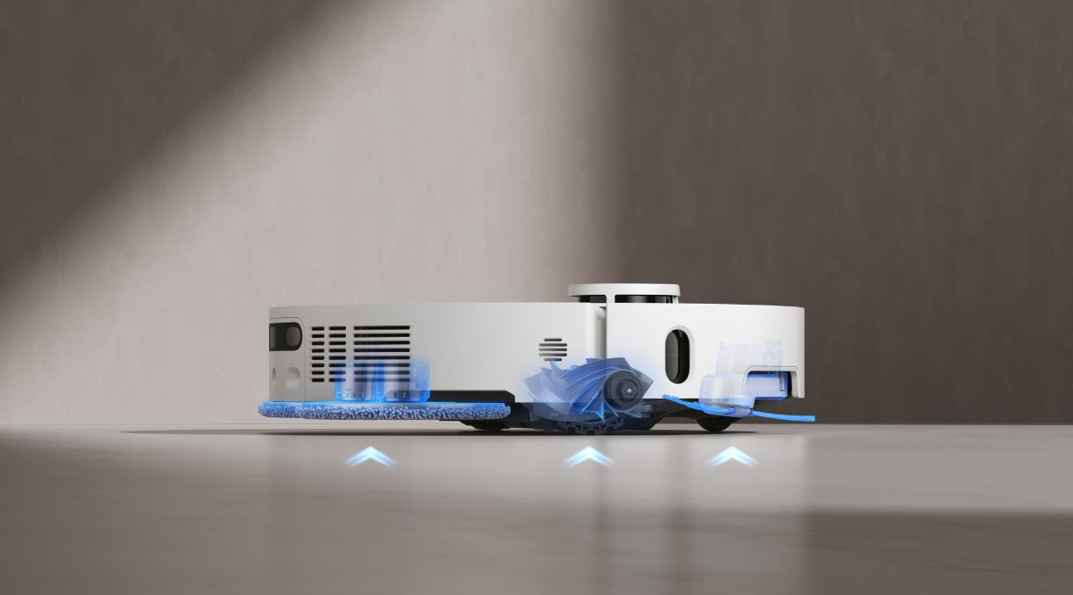A white Dreame X40 Ultra robot vacuum cleaner on a light-grey colored floor with blue arrows showing how its brushes and mops lift up