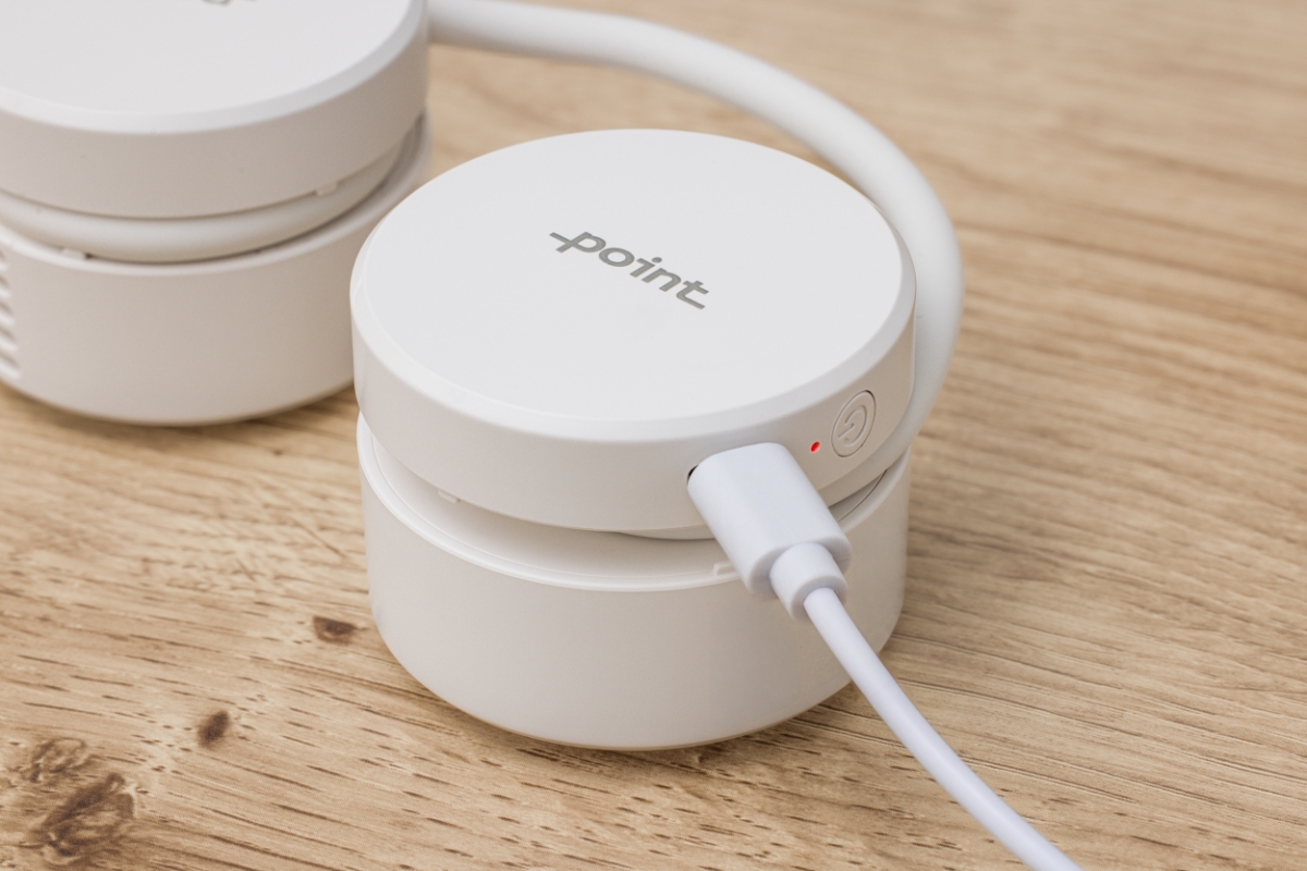 POINT NECK FAN WH White Point neck fan on a wooden table being charged with a white USB-C-charging cable