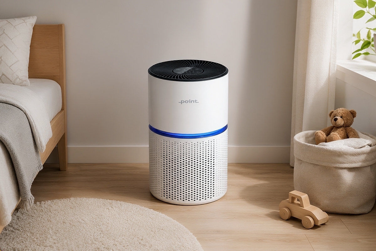 A white Point POAP220 air purifier in a children's room on a wooden floor with child's toys and a bed next to the purifier