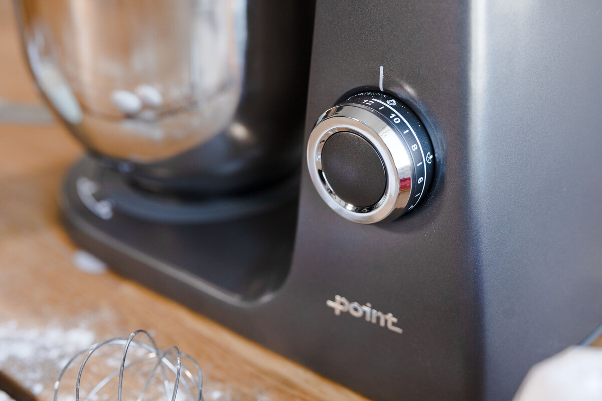 A close-up picture of a grey kitchen machine's switch with 12 speed settings