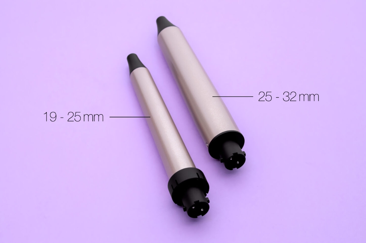 Close up of POINT SLEEK SWIRL PRO CURLING IRON curling barrels on purple background with their sized marked in black next to the barrels