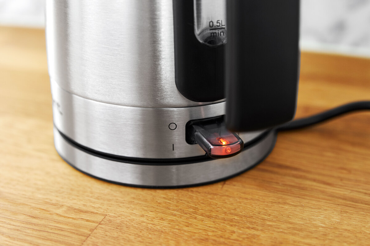 A close up of the on/off switch on the stainless-steel POINT POKE50SS1 kettle