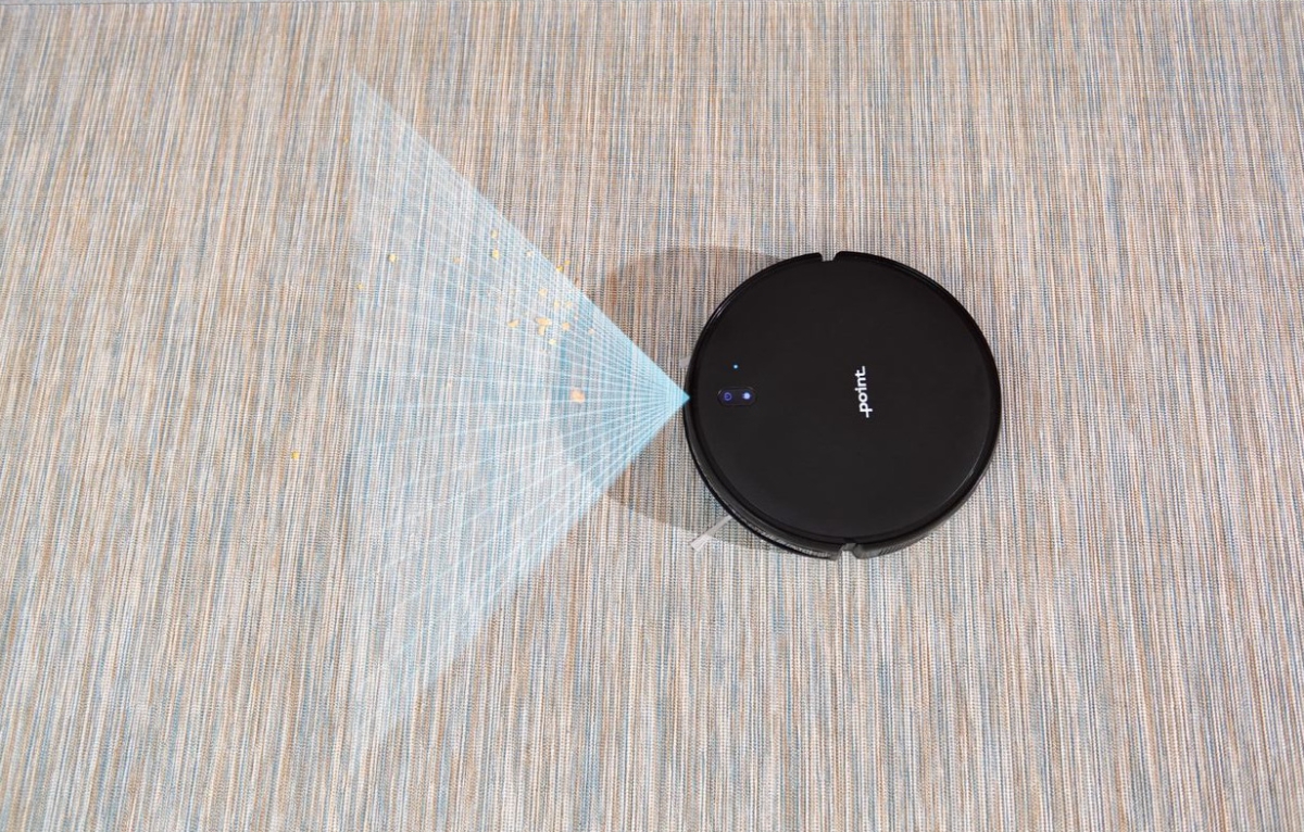 A black Point robot vacuum cleaner scanning a grey floor with it's blue laser showing on front of the device