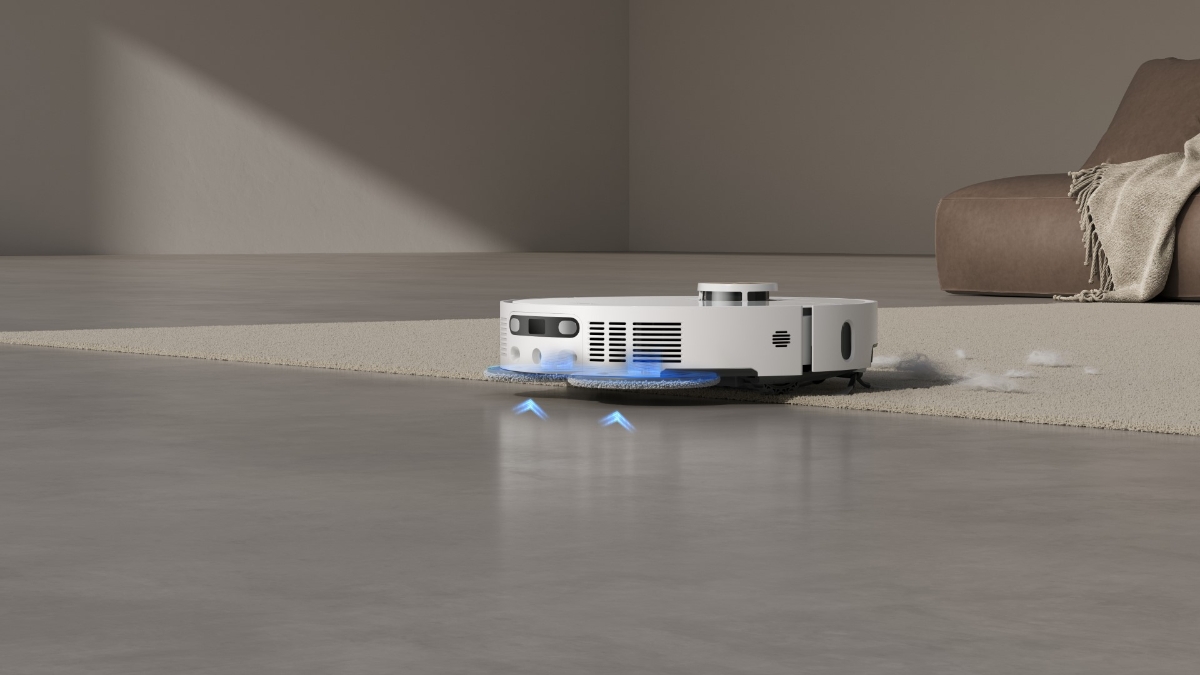 A white Dreame X40 Ultra robot vacuum cleaner moving from a light-grey shiny floor to a light-grey carpet with blue arrows showing how its mop pads lift up on the carpet