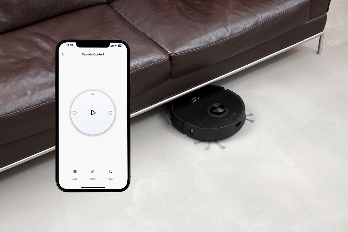Robot vacuum under the sofa and remote control with smartphone