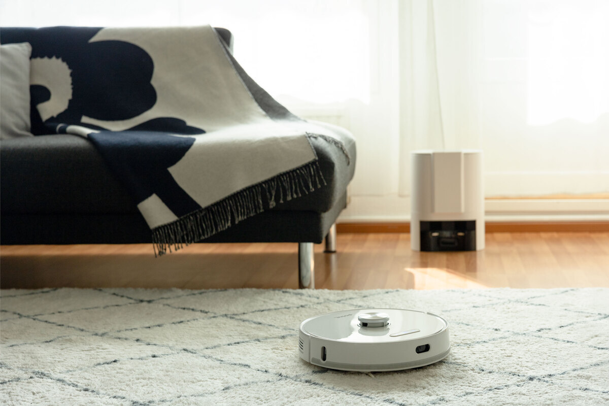 Robot vacuum on the carpet in the livingroom