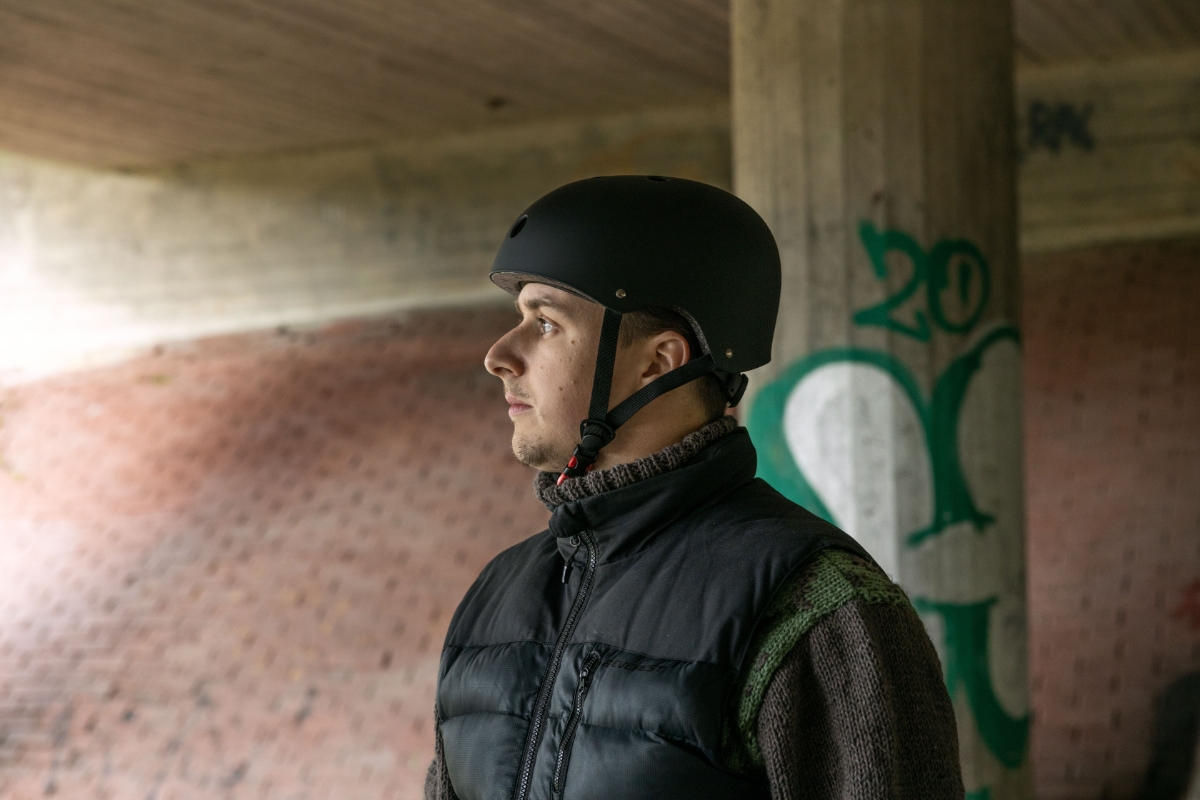 Man with a vest and cycling helmet