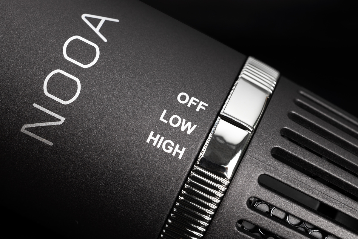 A close-up picture of a black NOOA hot air brush's handle with off, low and high temperature settings