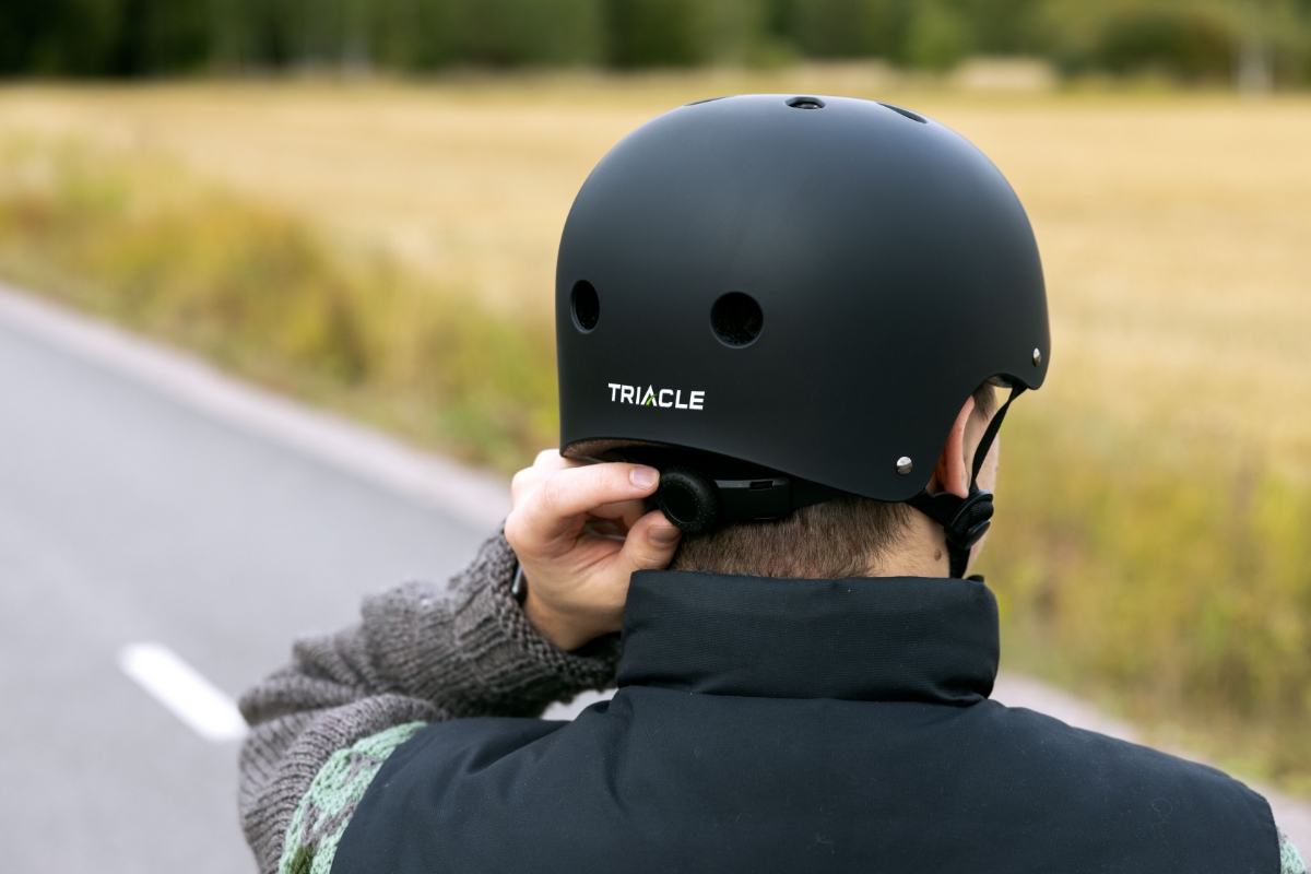 Person adjusting cycling helmet 