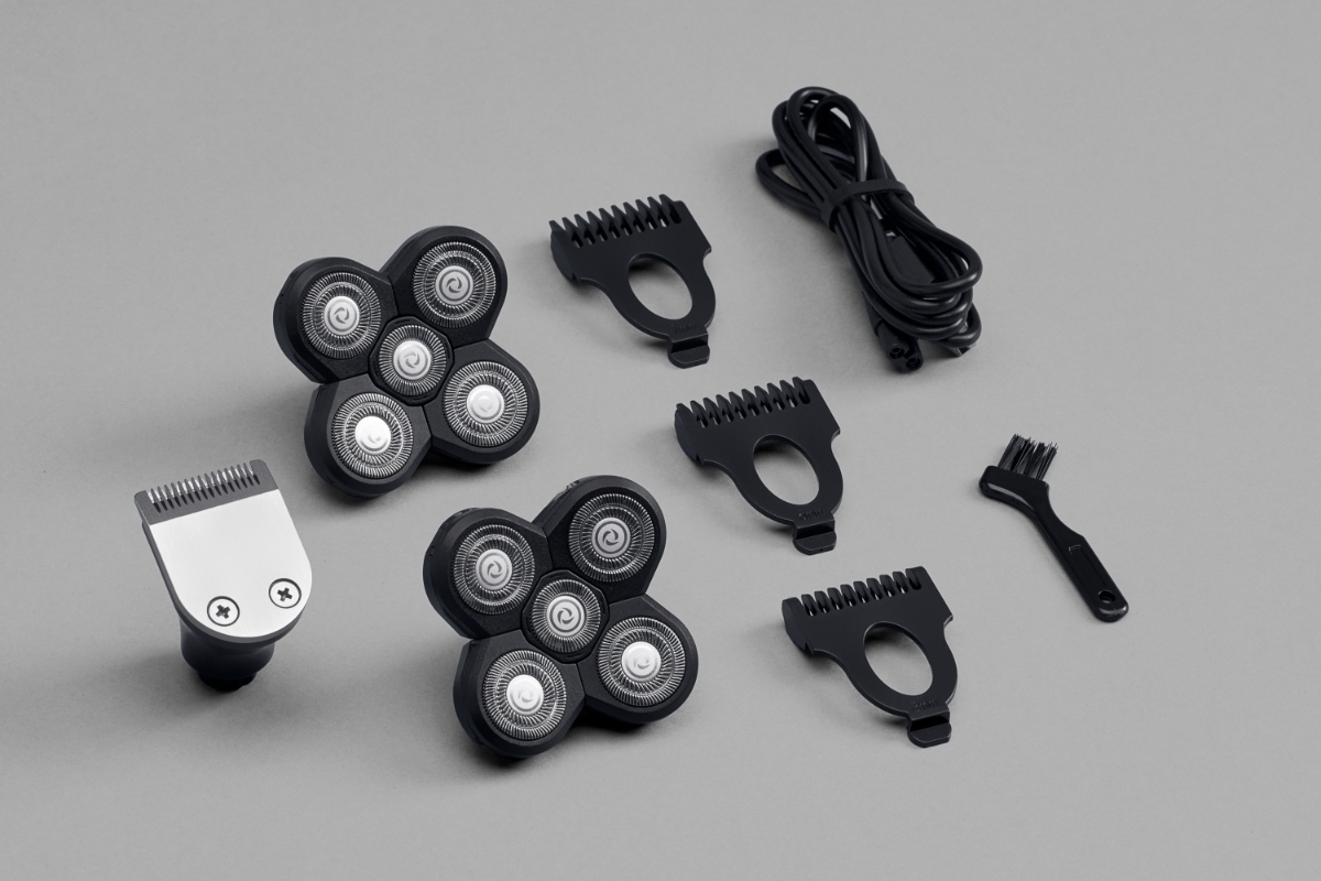 Wide angle image of all the accessories that come with POINT SMOOTH HEAD SHAVER against grey background