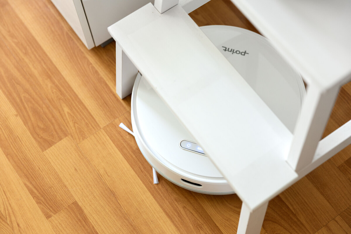 Robot vacuum under the kitchen chair
