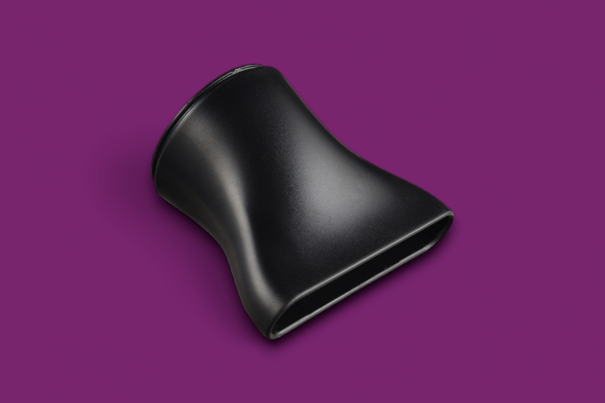 Close up of the concentrator nozzle of KULZ EASY DRY HAIR DRYER against fuchsia background