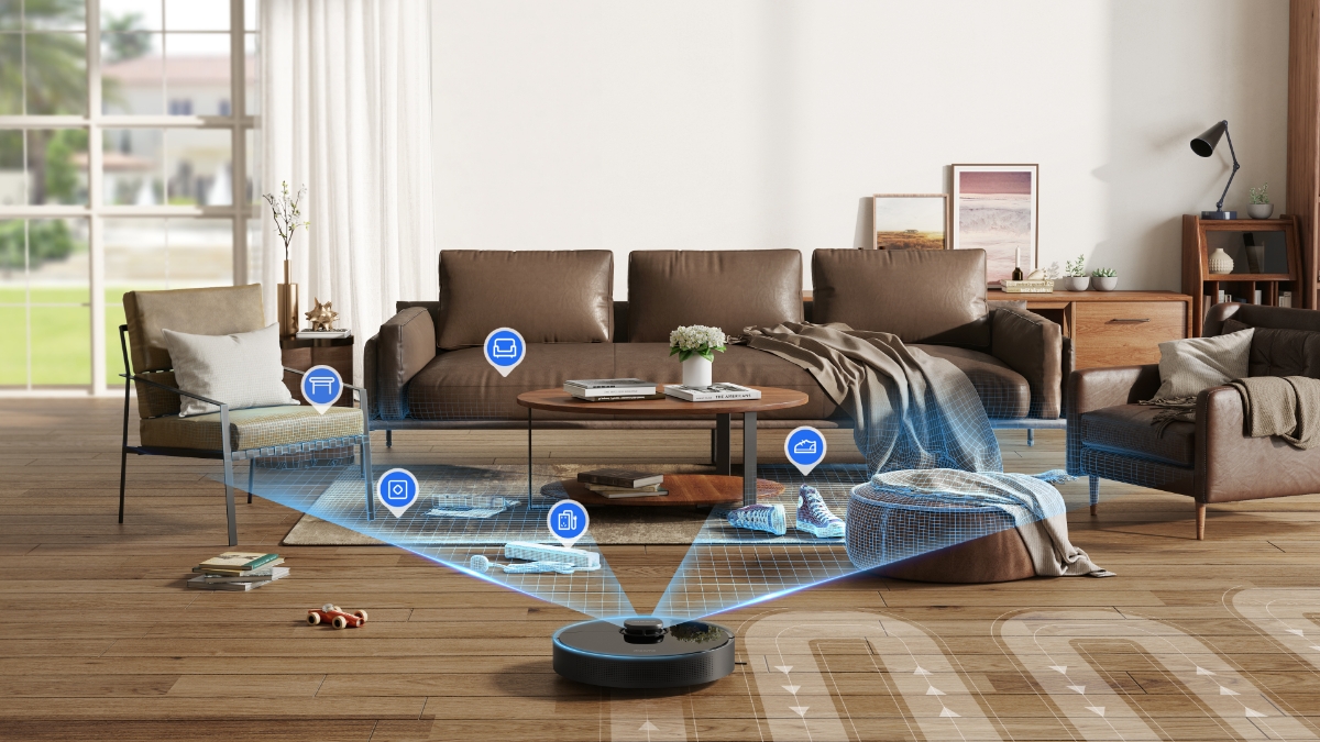 En svart Dreame-robotdammsugare på ett trägolv i ett vardagsrum som upptäcker en soffgrupp och andra små föremål framför den med blå laser