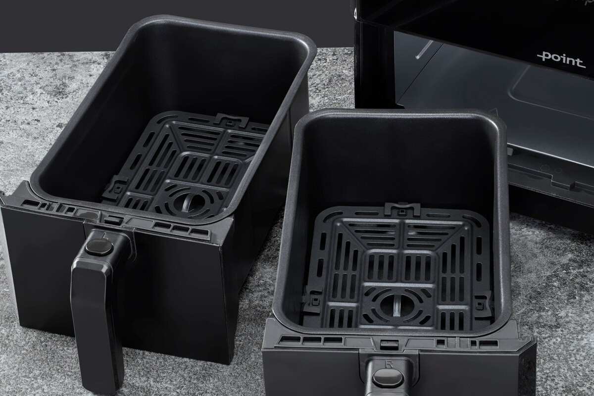 Close up of the airfryer dual baskets on the grey surface and black back ground