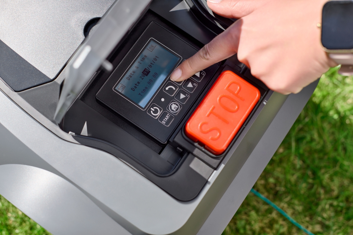Pressing the buttons of the display of the robotic lawn mower