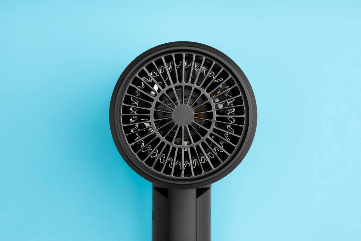 Picture of the back grille of the KULZ JETSET BLOW TRAVEL HAIR DRYER on blue background