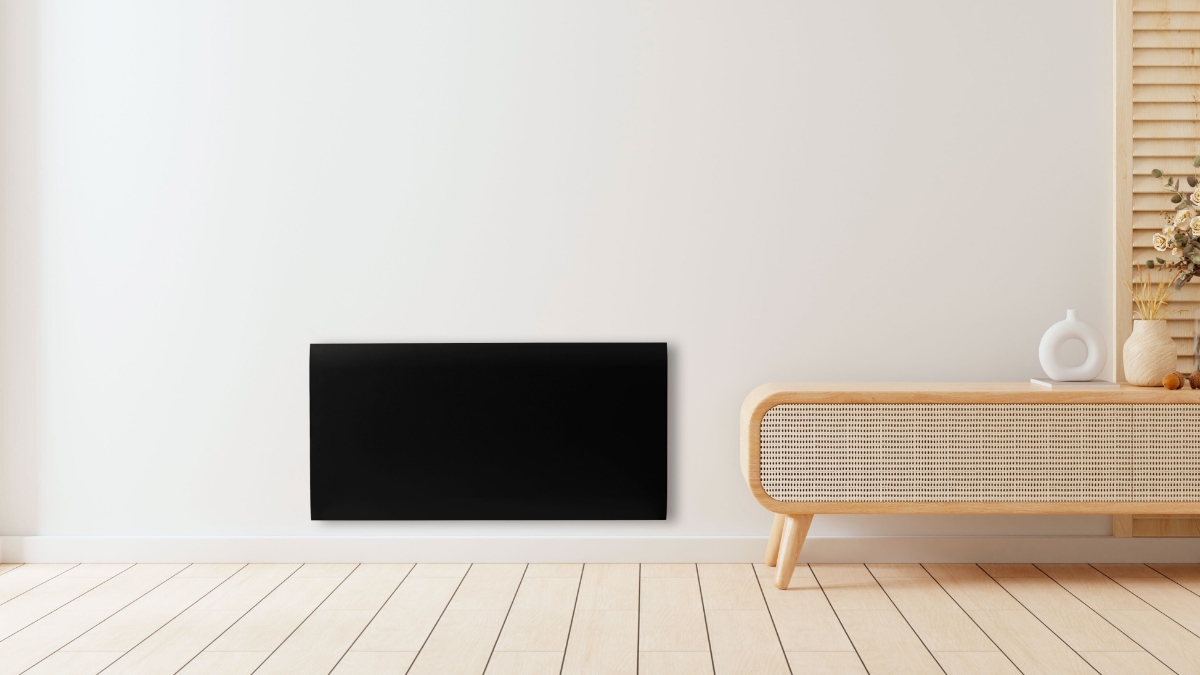 Wide angle image of the black POINT POPANW1000B PANEL HEATER on a white wall