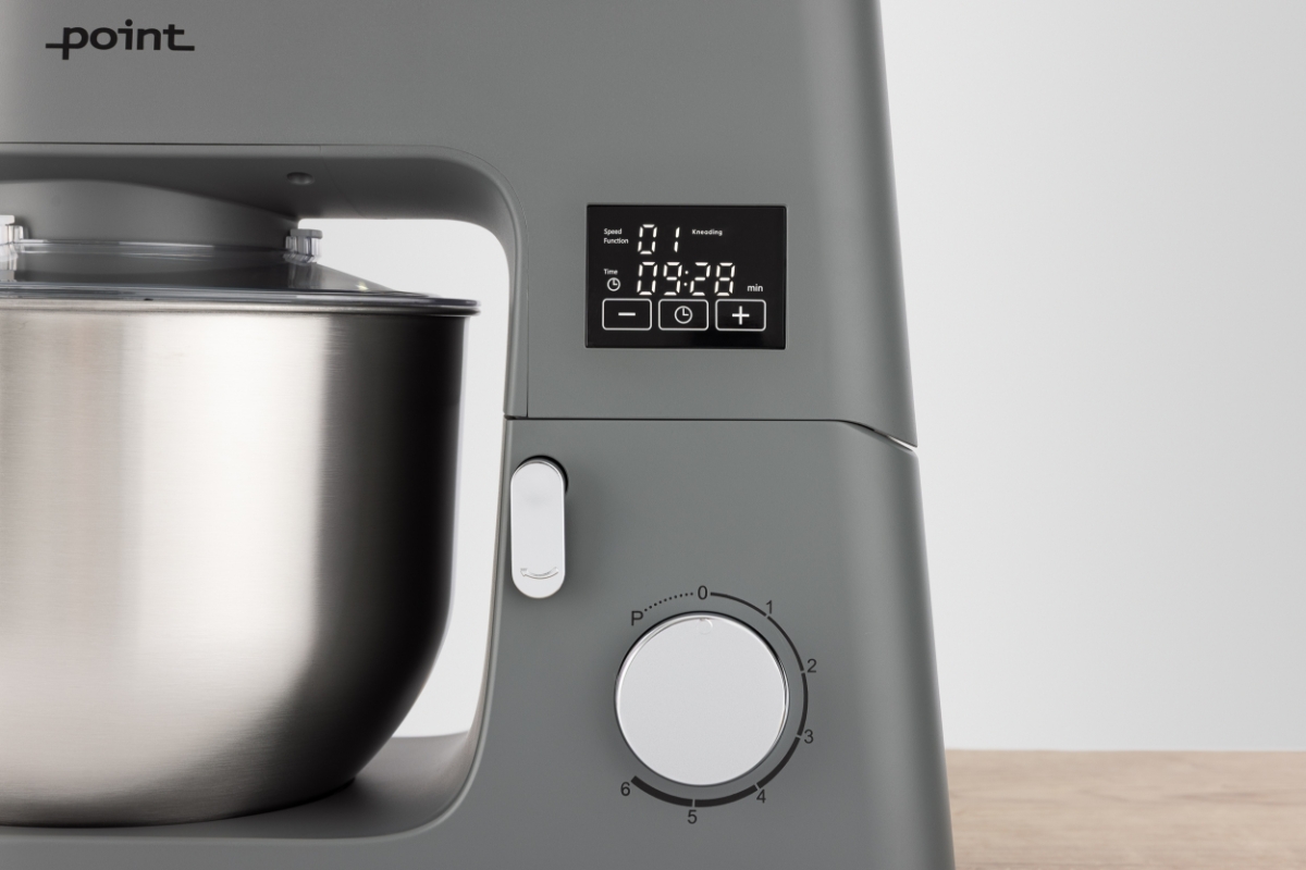 Grey-colored Point POKM5010 kitchen machine in an up-close image with its LED screen and adjustment knob showing clearly and a light-grey background