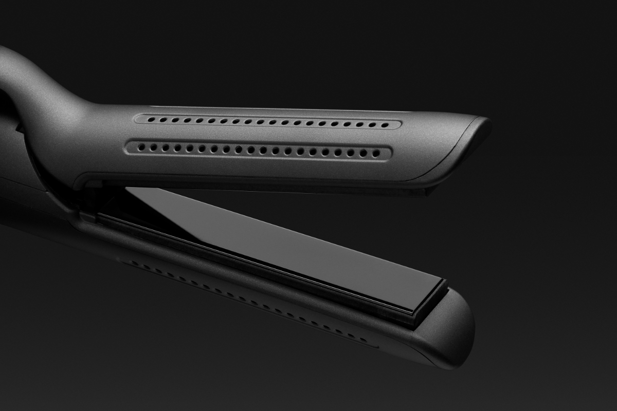 Close up of NOOA GEMINI CURLER & STRAIGHTENER and its rounded design against black background