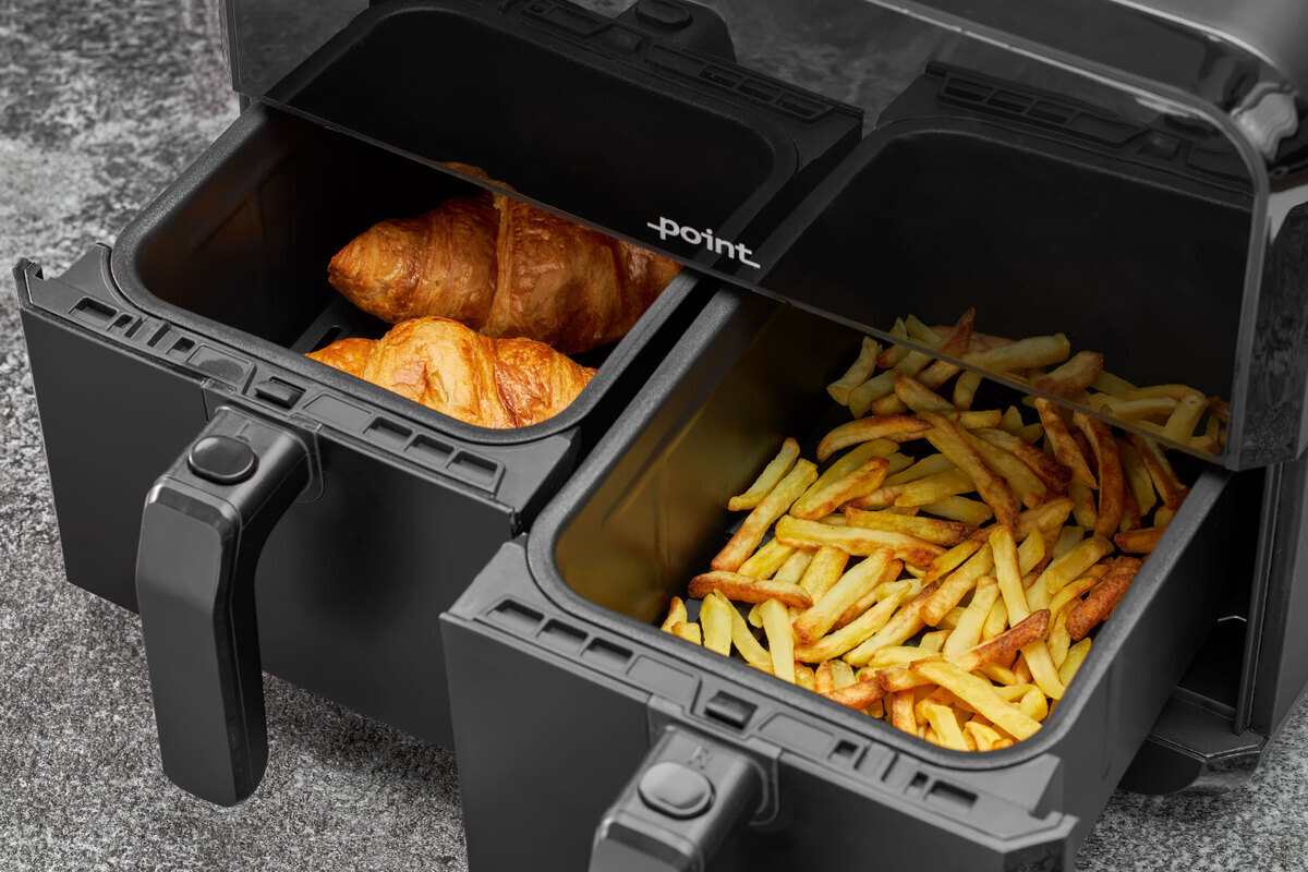 Close up of the airfryer dual baskets food inside on the grey surface