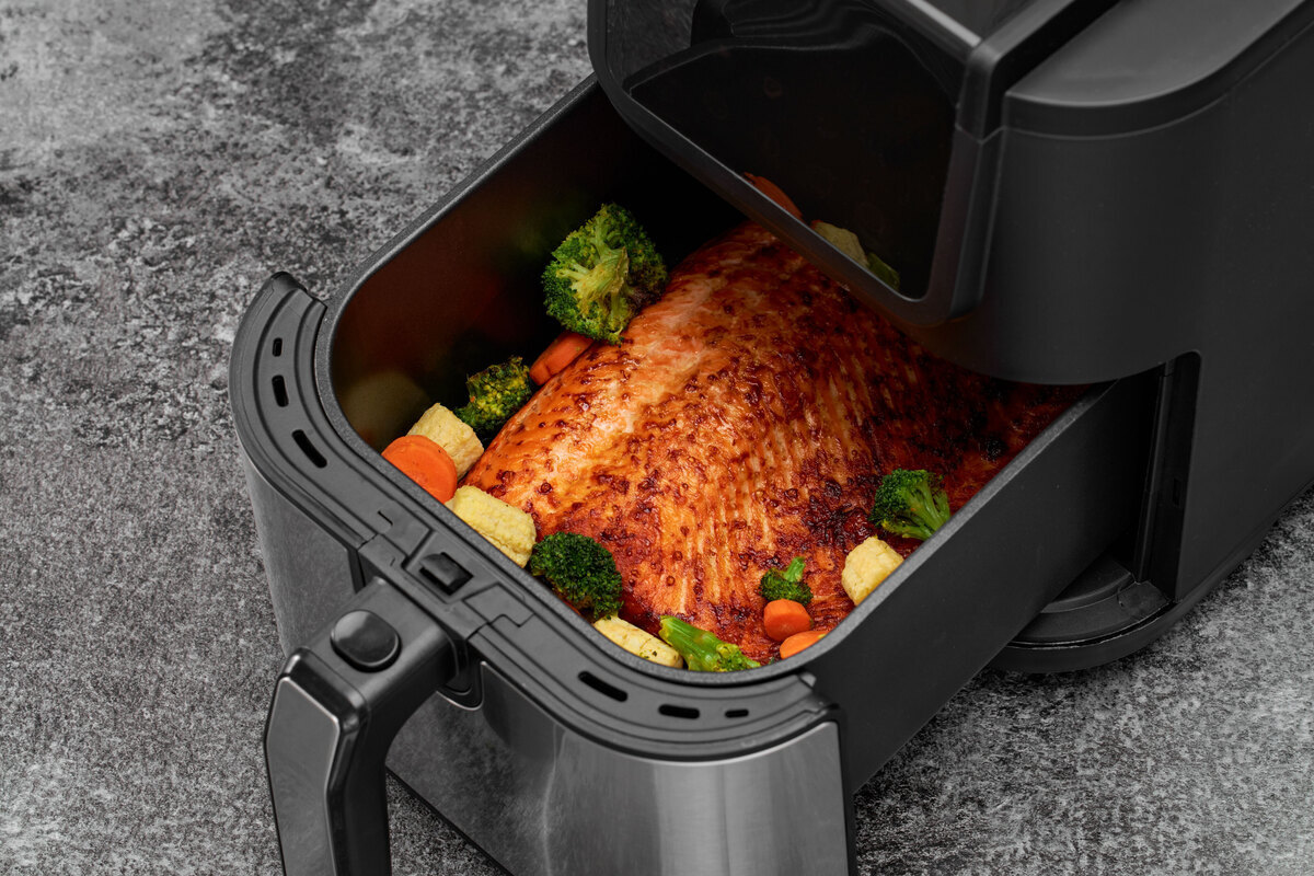 Close up of the airfryer basket fod inside on the grey surface