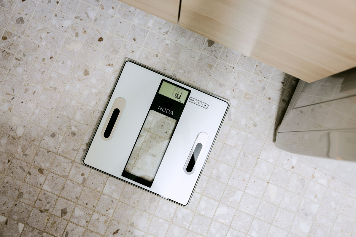 Body composition scale on the bathroom floor from above