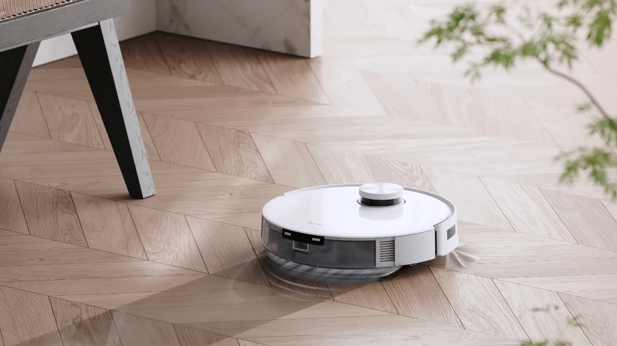 An Ecovacs robotic vacuum cleaner washing the wooden floors in the living room