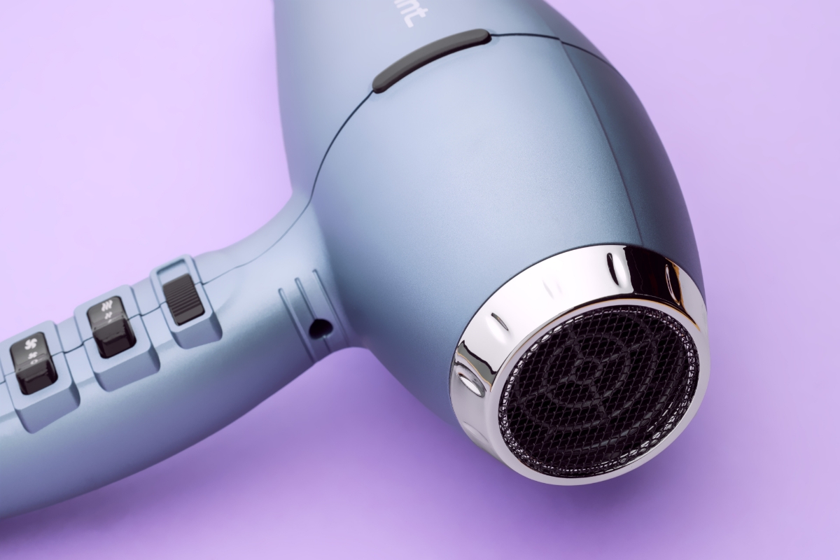 Close up of the back grille of the POINT POHD897AC RADIANT BLOW HAIR DRYER against a purple background