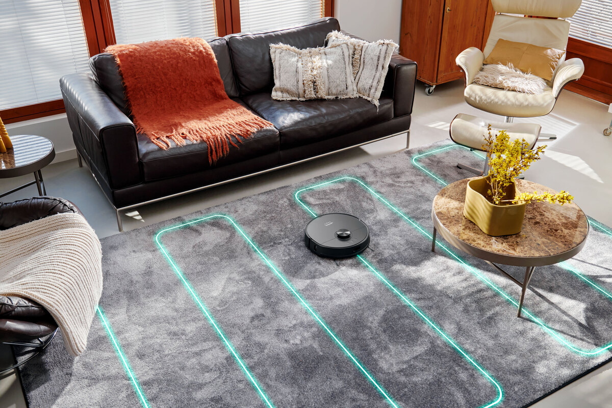 Robot vacuum vacuuming the livingroom carpet with cleaning pattern
