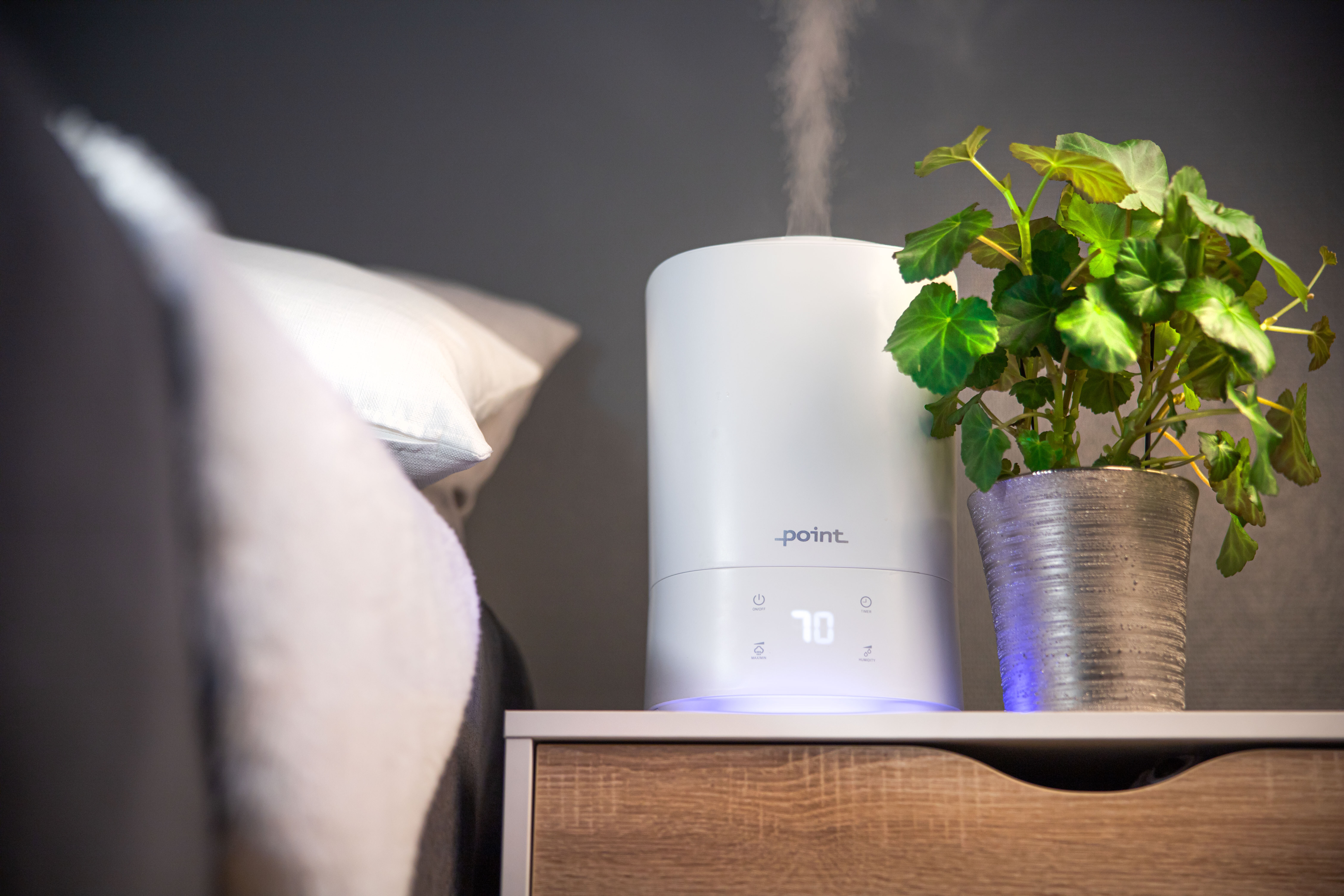 Humidifier on the bedside table next to a plant