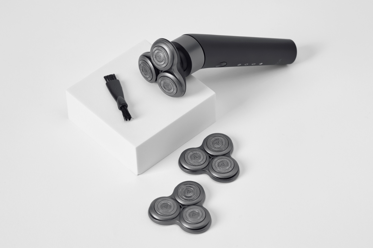 High angle view of NOOA TITAN SERIES 5 SHAVER and its shaver heads laid out on a white background