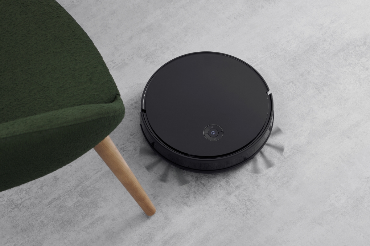 POINT DUSTY600 ROBOT VACUUM CLEANER navigating between the legs of an armchair