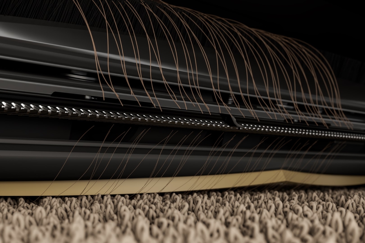 A black and dark yellow colored main brush of the Dreame X40 Ultra robot vacuum cleaner pictured up close