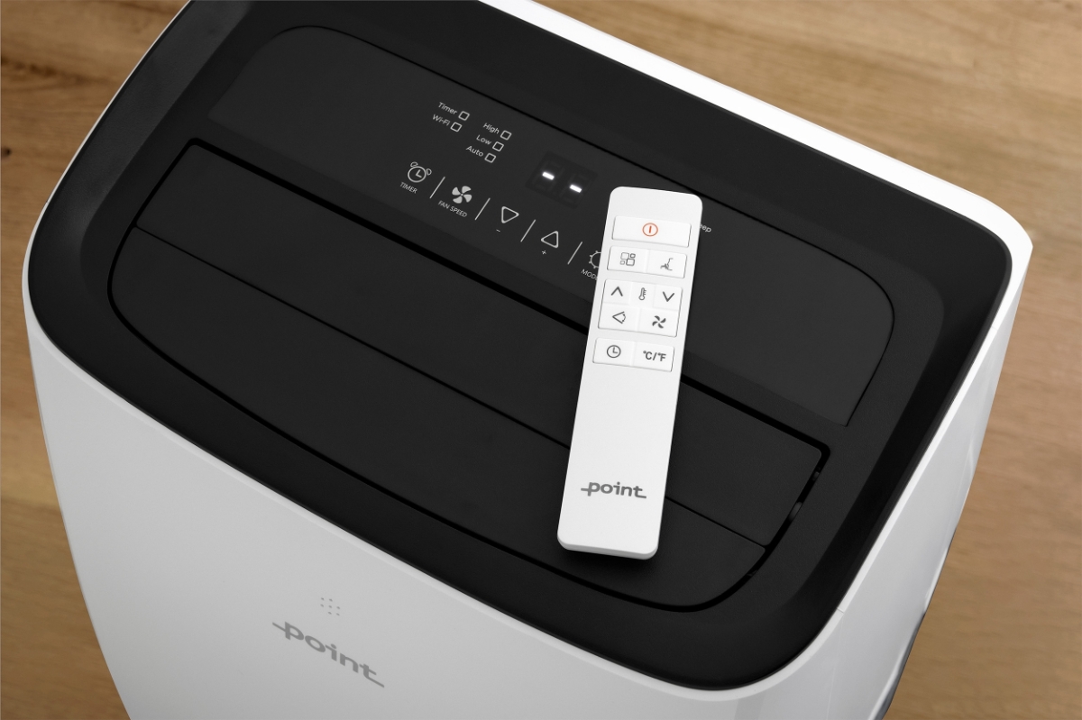 POINT POAC9K25SILW PORTABLE AC A white Point air conditioner with a black screen pictured from above the machine and the programs in the screen showing and the white remote control of the device placed on top of the screen