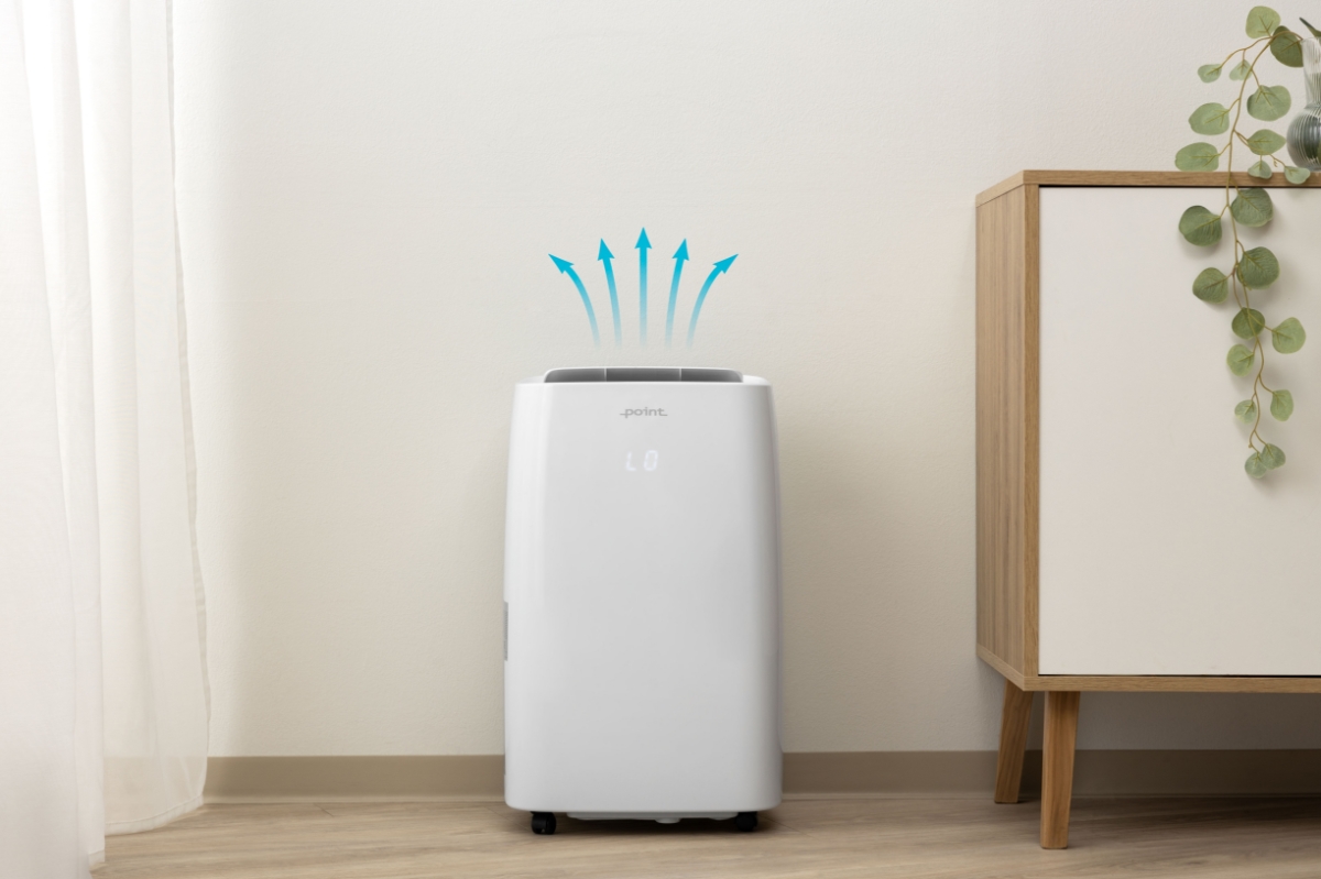 Wide angle image of POINT PODH3060 DEHUMIDIFIER with blue graphic arrows pointing upwards of it