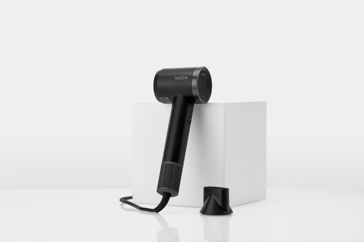 NOOA ASTA BLDC HAIR DRYER and the magnetic concentrator against a white background, the hairdryer leaning onto a white box