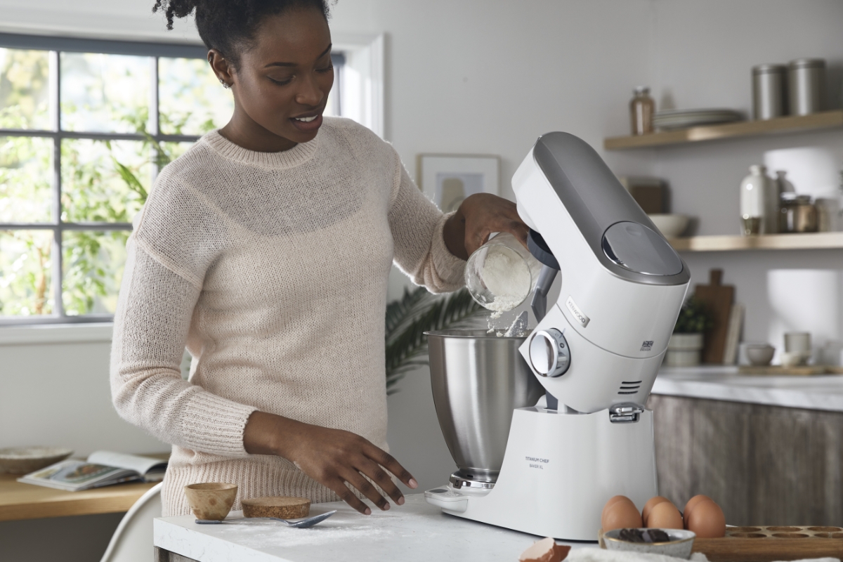 Kitchen machine on the table, woman using it
